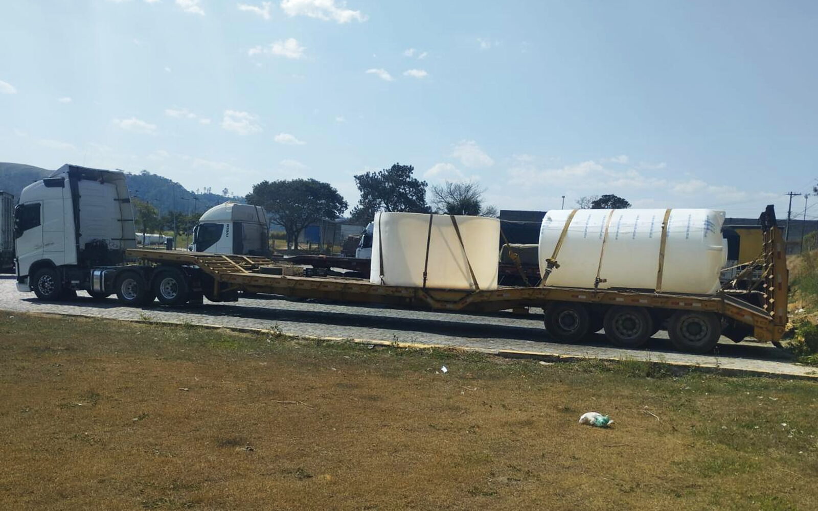 Conjunto da SAMV LOG com prancha carregada de reservatórios industriais, pronto para seguir viagem.